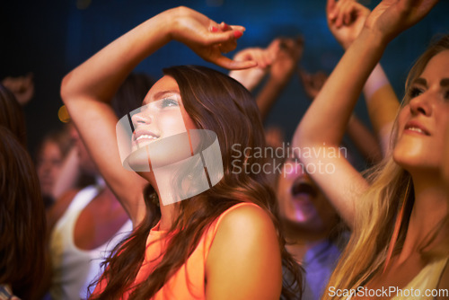 Image of Woman at concert, dance to music at festival in Florida, freedom and energy in audience, watch musician performance and dancing. Fun at music festival, social event and happiness watching live band.