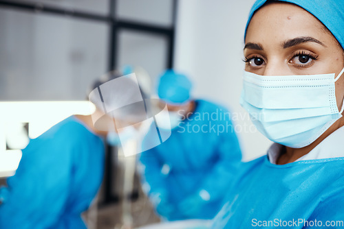 Image of Portrait of woman, surgeon and operating room, hospital and healthcare emergency, surgery or medical clinic. Young female doctor, nurse or worker in face mask, scrubs and working in operation theatre