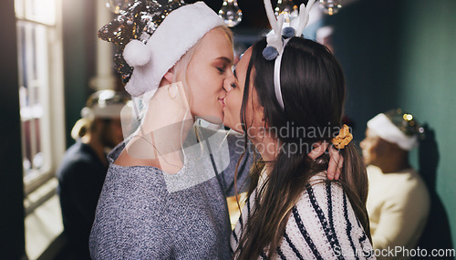 Image of Christmas, kiss and love with lesbian couple at party for celebration, festive and holiday. Lgbtq, gay and dance with women partners at xmas event for romance, social and relax at reunion gathering