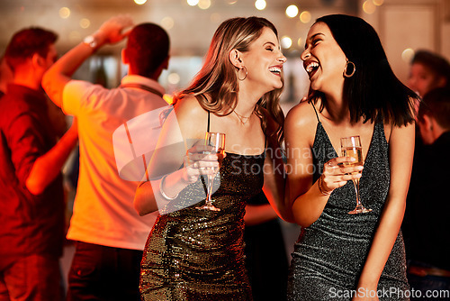 Image of Women, laughing or bonding in champagne night party, clubbing event or birthday celebration in New York. Smile, happy people or friends with alcohol glasses on luxury restaurant or disco dance floor