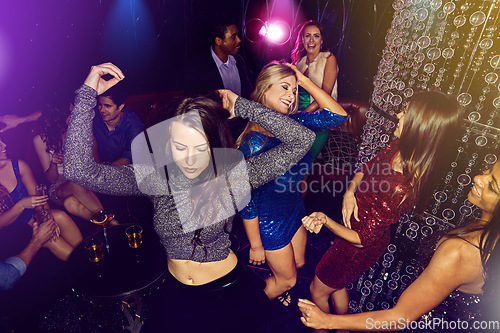 Image of Nightclub, dancing and women at party to celebrate birthday, happy hour or new years group energy and happiness on dance floor. Group, crowd and ladies night at club event with music and happy people