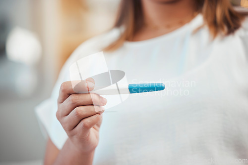 Image of Woman hands pregnancy test and reading for results, information or notification for baby in home. Girl, test and reading for pregnant, mother or family goal in house with blurred background in Dallas