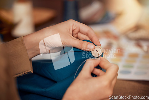Image of Womab, hands and sewing clothes button in studio for designer wear, fashion garment and creative fabric design. Tailor, boutique startup and fashion designer hand or seamstress working on clothing