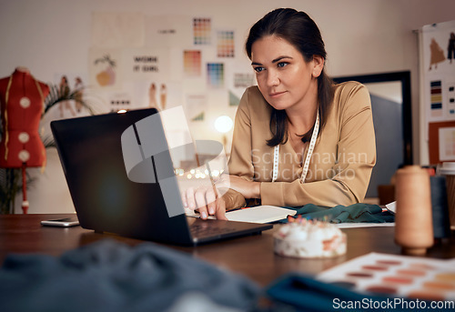 Image of Laptop, fashion and design with a woman tailor or seamstress typing a proposal in her workshop for creative style. Computer, ecommerce and reatil with a female designer at work for an online order