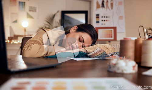 Image of Tired, design and woman in fashion sleeping at a desk with burnout, stress and creative work in boutique at night. Fatigue, stressed and tailor or designer with clothes for fashion design in the dark