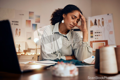 Image of Stress, headache and fashion, woman designer in studio with laptop, burnout and financial anxiety. Finance, debt and overworked tired black woman working late on clothing design deadline in office.