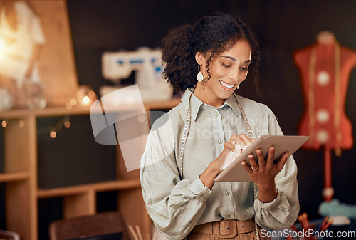 Image of Black woman, fashion designer and tablet for planning, internet and web ideas in textile studio. Happy tailor, digital technology and manufacturing startup, small business owner and creative workshop