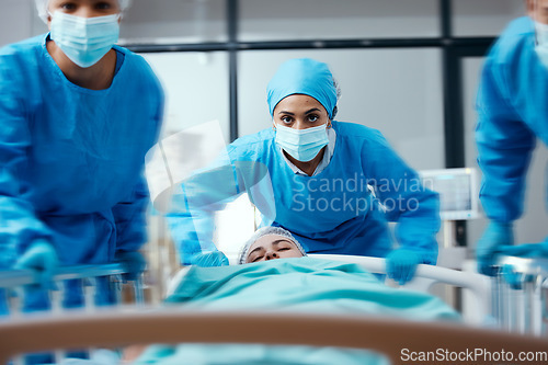 Image of Surgeon, bed and rush in a hospital for emergency operation in the er with a sick patient. Surgery team, pushing sleeping woman and fast hospital bed in the theater for surgical medicine procedure