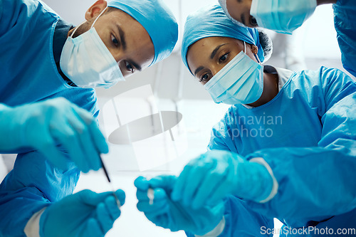 Image of Surgery, teamwork or doctors in a medical emergency operation theater with collaboration or team work helping a patient. Support, life insurance or focused healthcare workers in face masks working