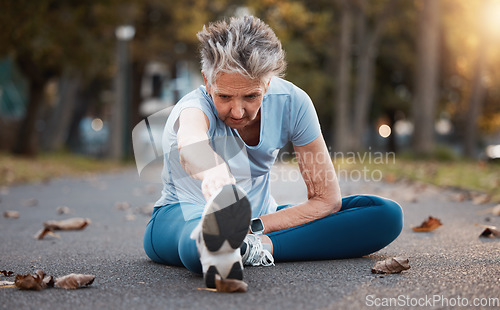 Image of Senior woman runner, street and stretching for healthy exercise, urban workout and outdoor training. Elderly lady, metro park and warm up for running, health or balance on road for wellness in Aurora