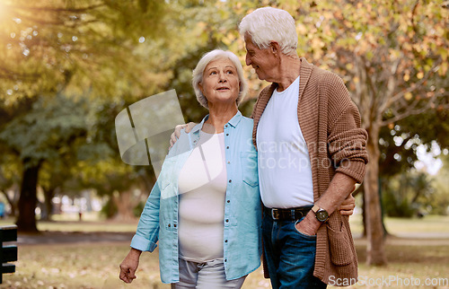 Image of Senior couple, bonding or walking in nature park, city garden or public environment in relax exercise, mobility or retirement break. Smile, happy woman or talking elderly man in hug and weekend date