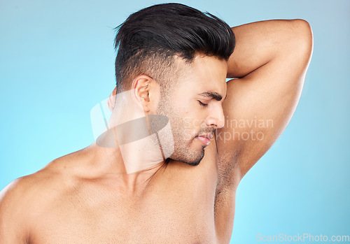 Image of Smell, hygiene and sweat with armpit of man for product, deodorant and cologne fragrance. Perfume, cosmetics and shower with model for antiperspirant, routine and underarm care in blue background