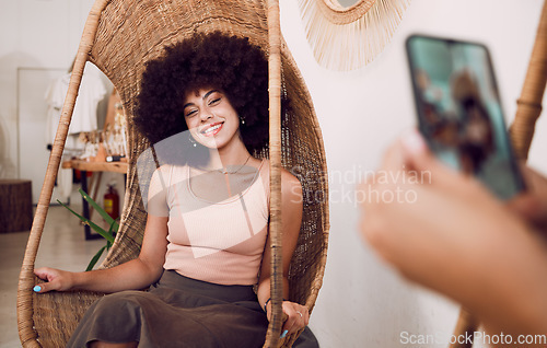 Image of Black woman, smile and swing chair with a phone for a photograph for social media, blog or online marketing or advertising. Face of influencer happy while posing for profile picture as network user