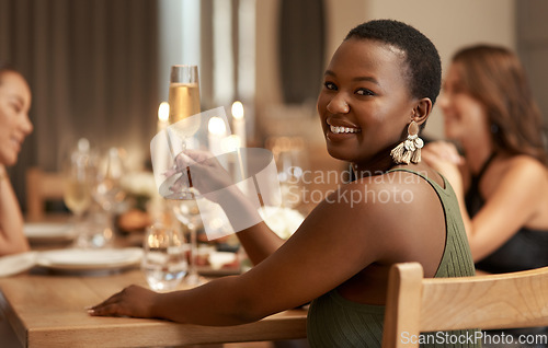 Image of Friends, champagne and portrait girl at dinner celebration party to celebrate happy new year in house dining room. Candle, home fine dining and black woman at social holiday event with alcohol drinks