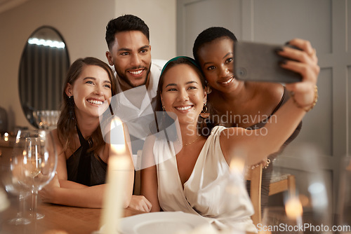 Image of Friends, phone selfie and dinner party, social media and communication in home for new year celebration and happy smile. Diversity and picture for internet post at night or holiday event with group