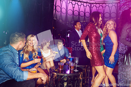 Image of Party, women and dancing at a nightclub with cocktail drinks, friends and lighting to celebrate new years, birthday or happy hour. Men and women people together for celebration at club or event