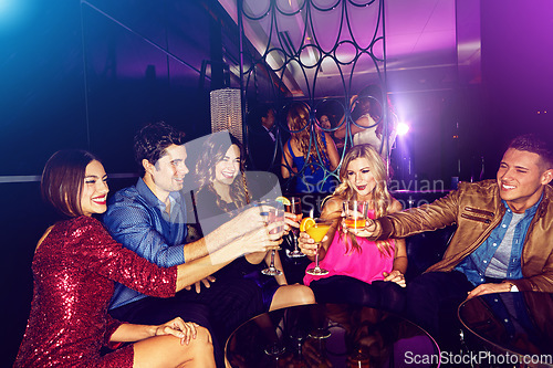 Image of Party, toast and new year with friends in a club, drinking during a celebration event together. Birthday, crowd and cheers with a man and woman friend group enjoying a drink while bonding in a club