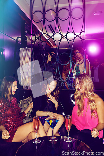 Image of Party, new years eve and women drinking in a nightclub while having fun with comic communication. Talking, laughing and friendship with partying group of ladies enjoying nightlife and cocktail drinks