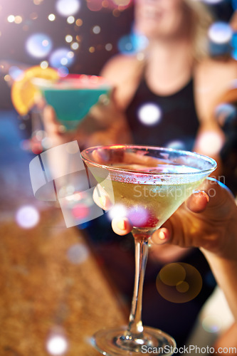 Image of Hand, cocktail and nightclub with a woman at a bar for drinking, fun or new year celebration closeup. Party, birthday and glass with a female enjoying a drink while clubbing for weekend nightlife