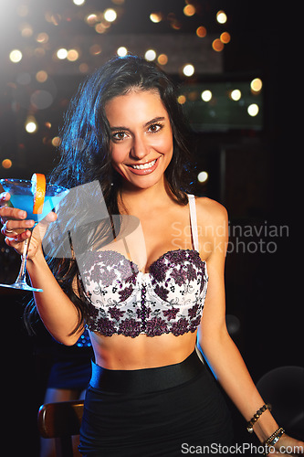 Image of Portrait, drink and stylish woman in a nightclub ready to party and have fun at a concert or event. Face, front or happy trendy female drinking cocktail at a New Years eve disco while partying