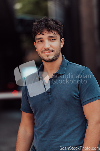 Image of A portrait of a modern man, exuding confidence and style, against an outdoor backdrop, showcasing his charisma and fashionable demeanor.