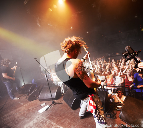 Image of Rock, music festival and band guitar performance with crowd, fans and people cheering. Punk concert, man musician and fun social party event with music celebration and new year show at nightclub