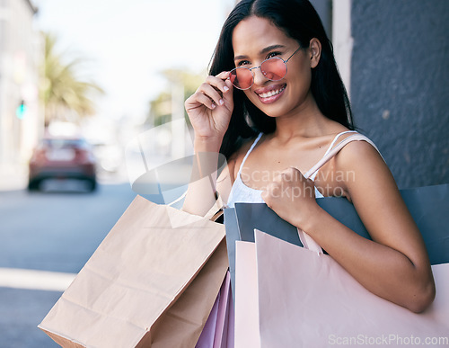 Image of Retail, shopping bag and sunglasses with woman in city for summer, sales and products purchase. Luxury, deal and promotion with girl customer and expensive package for consumer, fashion and spree