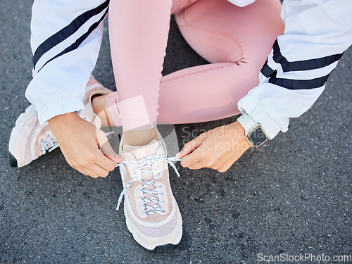 Image of Sports, shoes and woman legs for running, training or workout on asphalt road or urban street with fitness fashion for health or wellness. Runner getting ready on ground for exercise with sneakers