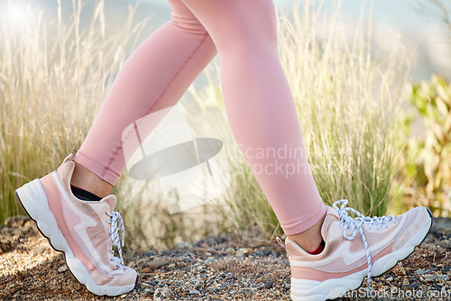 Image of Fitness, running and shoes of woman on trail for jogging, trekking or adventure in nature. Workout, exercise and hiking with girl runner training on countryside path for jogging, endurance and cardio