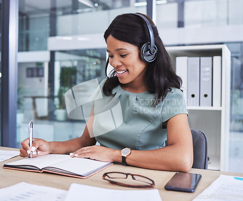 Image of Headphones, notebook and writing with business woman for research, consulting and conference. Data, administration and information with black woman in office for knowledge, planning and idea