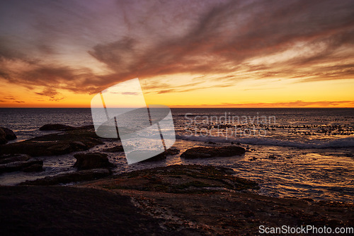 Image of Sunset, beach and landscape of natural environment, ocean and sea during night in summer. Sky, nature earth and sunrise in horizon in a tropical, calm and location with peace in Thailand on an island