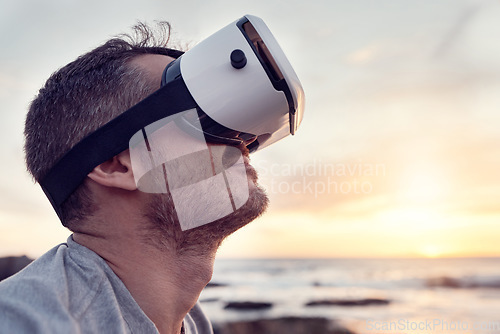 Image of VR, beach and metaverse with a man in a nature using a wireless headset to access the internet. Future, virtual reality and ai with a male 3d user by the sea or ocean with cyber technology at sunset