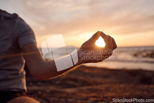 Image of Beach meditation, sunset and hands of man meditate for peace, freedom and chakra energy healing of soul aura. Sun flare, lotus and spiritual yogi relax at ocean sea for zen mindset and mindfulness