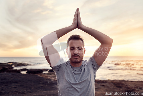 Image of Zen man, beach meditation and sunset for peace, wellness or healthy mindset by waves in summer. Yoga, prayer hands pose or mindfulness by ocean, sunshine or relax for chakra energy balance in Hawaii