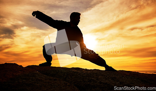 Image of Man, meditation and silhouette, training and tai chi outdoor at a beach, wellness and calm with sunset background. Male, dark and shadow with martial arts, workout and meditate for a balance mindset