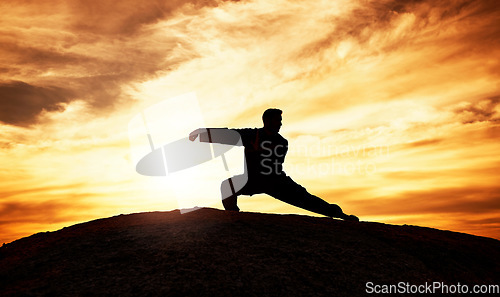 Image of Tai chi, exercise and man at sunset to practice a spiritual workout in nature with an athlete. Silhouette, martial arts training and male fitness practitioner doing chi gong on a hill at sunrise