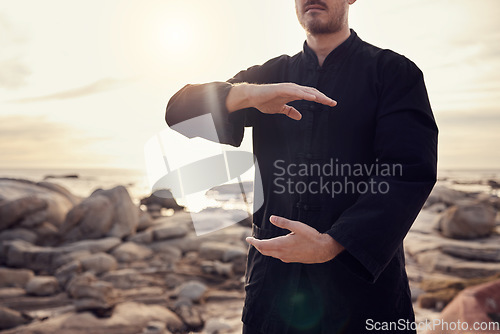 Image of Health, fitness and tai chi with a man using martial arts for spiritual wellness and exercise by the beach. Fit, strong and asian zen lifestyle with chi gong by the seaside and a male active person