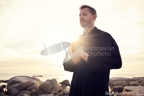 Image of Meditation, zen and tai chi with man at beach for spiritual, fitness and healing energy at sunrise. Peace, relax and balance with guy and breathing exercise for philosophy, faith or wellness training