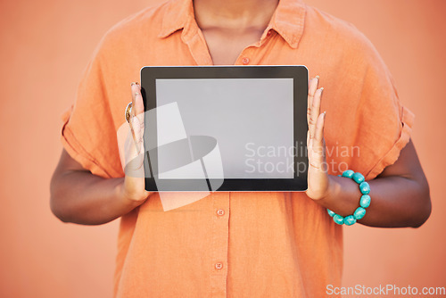 Image of Marketing, advertising and woman with mockup tablet in hands, cropped on studio background with space for product placement. Digital Marketing, blank screen and orange campaign for web advertisement.