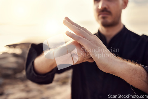 Image of Karate, welcome or hands of zen man with peaceful, calm or mindfulness in nature at a beach for meditation. Fitness, sunset or martial arts teacher training with focus, motivation or spiritual energy