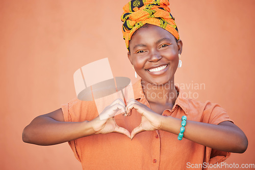 Image of Black woman, hands or heart sign on wall background with fashion, trendy or stylish clothes for love, support or trust. Portrait, smile or happy student and hand gesture, hope emoji or orange mockup