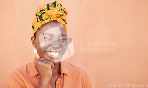 Image of Black woman, face and smile with a turban and free space for African culture, happiness and beauty mockup on peach background. African female with Nigeria tradition fashion head scarf while laughing