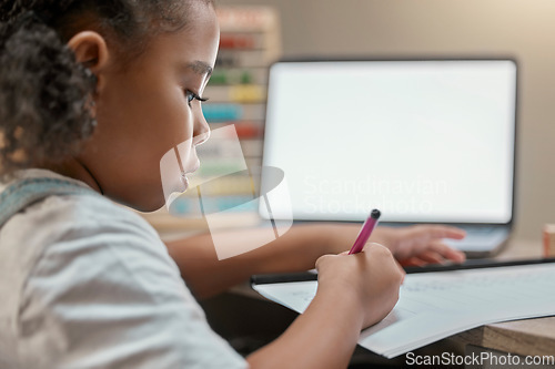 Image of Home, elearning and little girl writing on paper with mockup screen on laptop for education. Focus, remote student and black child busy with homework at study desk in house with concentration.