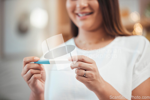 Image of Woman, hand and pregnancy test result with a happy mother to be ready for her baby at home. Mom, pregnant stick test and excited female ready for children or babies feeling happiness about family