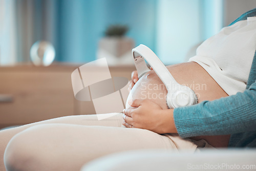 Image of Relax music, pregnant and stomach of a woman on the sofa for peace, calm and sound for baby during pregnancy. Radio love, streaming and mother with audio therapy with headphones for child on tummy