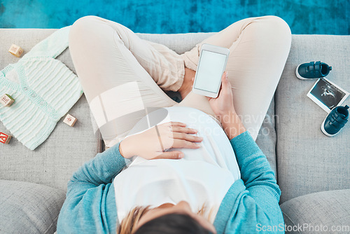 Image of Woman, pregnant and phone screen, branding and mockup space for advertising, social media and relax on sofa with toys, above and baby cloths in home. Mother, 5g smartphone and reading online post