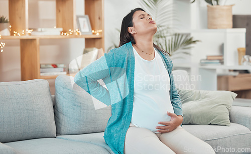 Image of Pregnant woman, breathing and stomach pain on sofa in living room for childbirth wellness, pregnancy healthcare or mother with backpain. New mom, stress and painful prenatal care or breath on couch