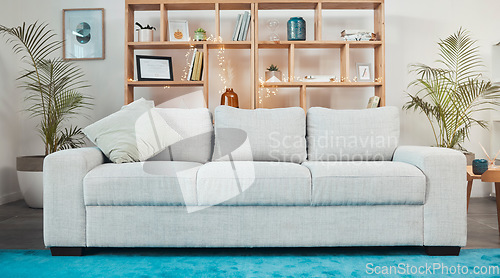 Image of Interior design, room and furniture with a sofa in the living room of a luxury, modern and empty home. Real estate, seating and wealth with a couch in an apartment for accommodation or lifestyle