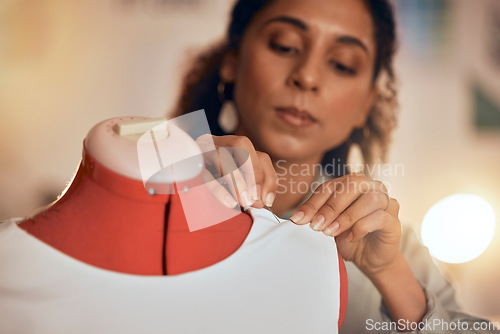 Image of Fashion designer, hands and sewing fabric on a mannequin at night while working in workshop for manufacturing, production and design process. Female entrepreneur, dressmaker or tailor making clothes