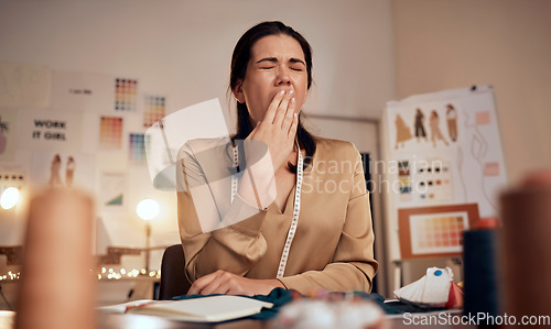 Image of Tired fashion designer, woman and yawn while working at night in creative office, textile studio or startup. Exhausted, sleepy and overworked tailor yawning in burnout, stress and fatigue in workshop